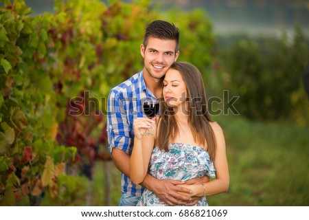 Couple celebrating their anniversary and holding each other in vineyard