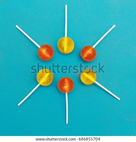 Lollipop Flat lay Minimal concept Six multicolored round lollipops are lying on a light blue background Trendy bright photo in modern pop art style Top view