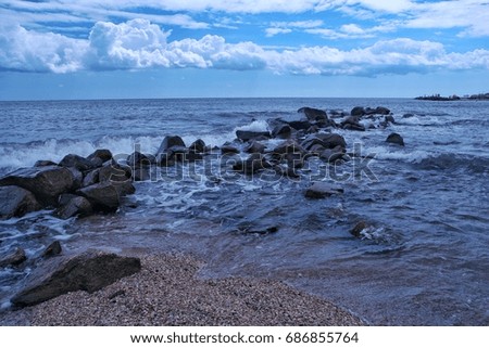 The sea  tide , the waves and stony seashore