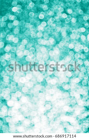 Abstract teal green glitter sparkle confetti background for turquoise happy birthday party invite, aqua mint holiday card, white engagement, xmas advert or defocused Christmas fairy lights bokeh blur Royalty-Free Stock Photo #686917114
