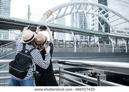 Young traveler shoot photo between walking in city