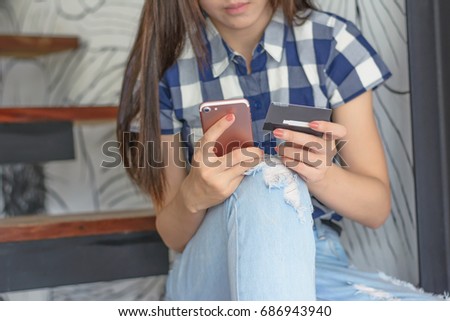 Asia woman holding credit card and mobile phone