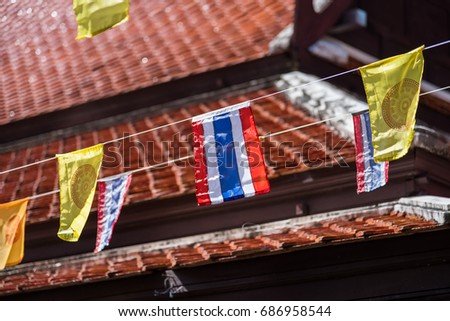 Thai flags and buddhism yellow flags in the temple