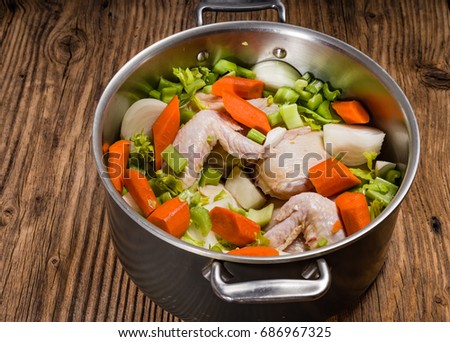 Metal stock pot with soup ingredients for chicken soup