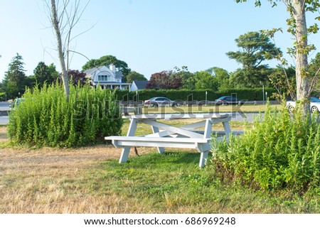 Picnic table on a green grass with blue sky