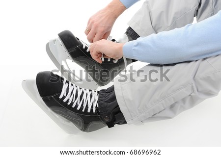 Man tying shoelaces hockey skates. Isolated on white background