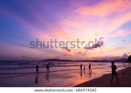 Sun set at beach with beautiful sky, people walking and enjoying at the beach
