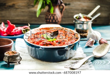 Ratatouille on woden rustic background, baked vegetables in tomato sauce with basil and paprika Royalty-Free Stock Photo #687008197