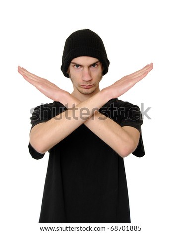 Serious and determined young man makes an X shape with his arms and hands. This could mean stop, cross, or "extreme".