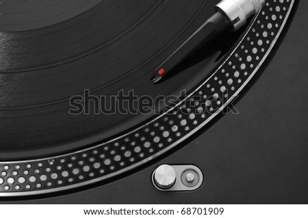 DJ record turntable. Macro closeup of the needle on a 12 inch vinyl LP playing hiphop techno rave beats.