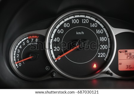 Car speedometer in the front panel of steering wheel showing speed and fuse gauge.