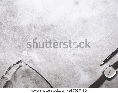 This is office equipment in minimal style, The picture of pencil, glasses and watch on cement background. soft tone color,  minimal style