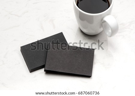 Business card blank over coffee cup and pen at office table.