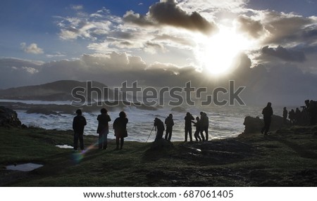 Silhouettes of photographers fond of giant wave photography on the Galician coast, Spain, sun, sunset,water,clouds,sky,foam,cliffs,tourism,touristic,view,travel,