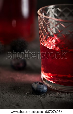 Soda water with blueberry syrup sparkling dark background photo