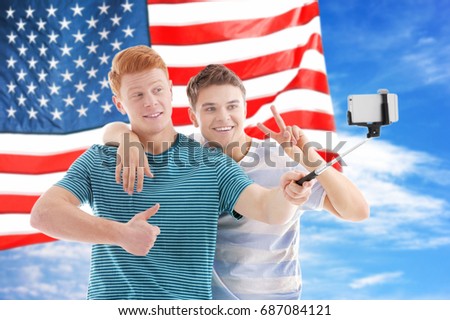 Friends tacking selfie and USA flag on background