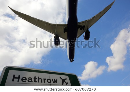 Civil passenger airplane landing at London Heathrow international airport. Royalty-Free Stock Photo #687089278