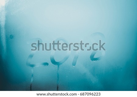 2018 sign draw on wet condensated window glass, blurred texture abstract background, close up view photo