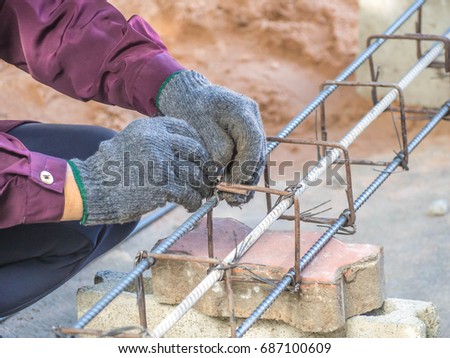 Lady worker was working on a Steel rod wearing glove.