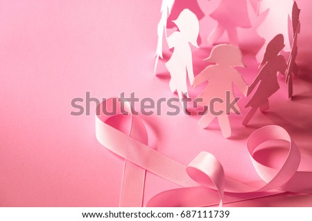 Sweet pink ribbon shape with girl paper doll on pink background  for Breast Cancer Awareness symbol to promote  in october month campaign Royalty-Free Stock Photo #687111739