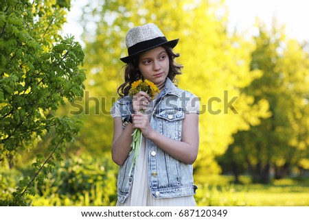 Girl in the park in the evening of a sunny day in the spring
