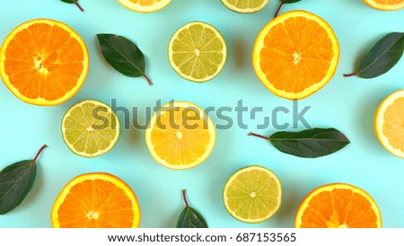 Mixed citrus fruit on aqua blue table overhead, slices knolling flat lay..  Royalty-Free Stock Photo #687153565
