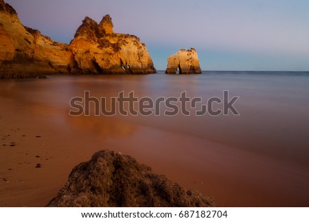 A long exposure, blue hour picture of the Alvor beach in Algarve, Portugal
