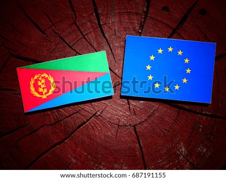 Eritrean flag with EU flag on a tree stump isolated