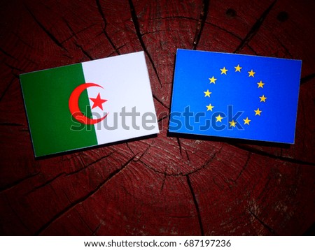 Algerian flag with EU flag on a tree stump isolated