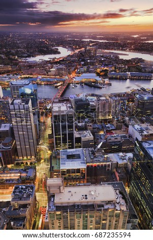 Elevated bird eye view of Sydney city CBD towards West at sunset over Darling harbour, Anzac bridge and western suburbs with setting sun. Royalty-Free Stock Photo #687235594
