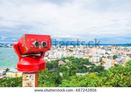 Touristic telescope look at the city Pattaya , Thailand. Close up metal binoculars with Pattaya city and blue sky background.