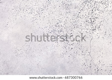 white cement wall with gravel of small stones