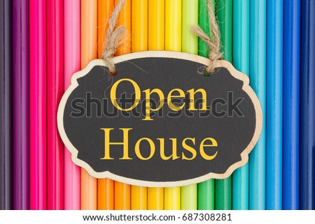 Open House text on a chalkboard with colorful pencil crayons