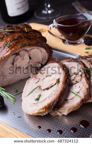Turkey Thigh Roll Stuffed Rosemary, Thyme, Parsley, Butter and Bacon on the top sliced on cutting board with Spicy Blackberry Sauce