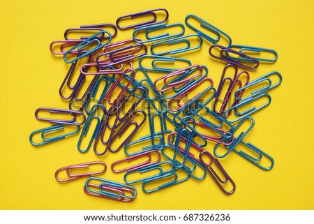 office paper clips on yellow background