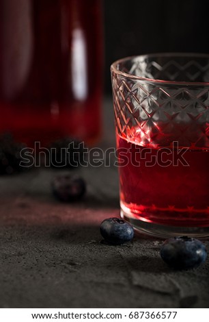 Soda water with blueberry syrup sparkling dark background photo