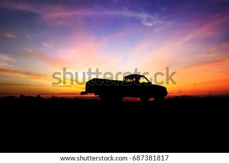 Silhouette of pickup truck on the background of beautiful sunset
