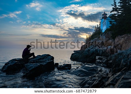 Photographer taking picture of Bass Harbor Lighthouse at Sunset with Beautiful Sky