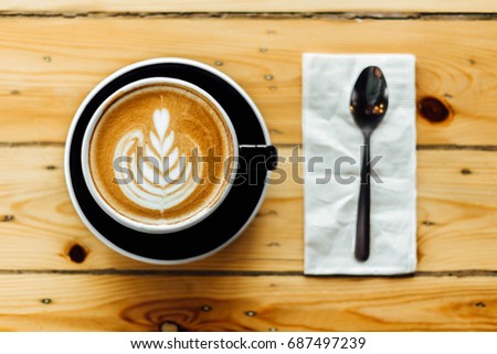 Latte art coffee and a spoon