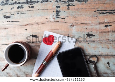 Cup and phone on the old wooden background. Top view, trend concept.