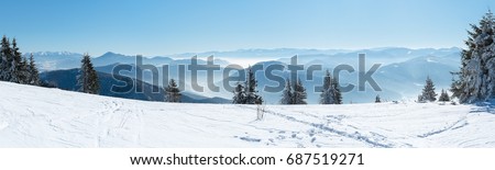 Beautiful  alpine panoramic view snow capped mountains, European beautiful winter mountains in Alps, Slope for cross country skiers in landscape Royalty-Free Stock Photo #687519271