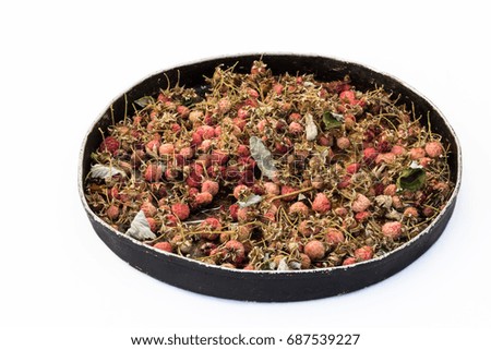 Drying Raspberry tea on frying pan pan