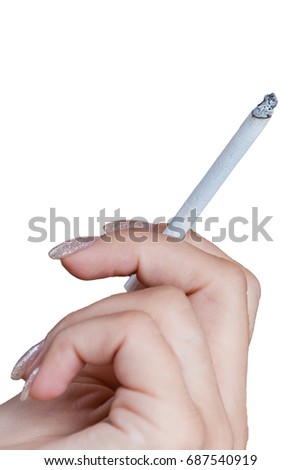 Female Hand holding a cigarette isolated on white background, fingernails nicely manicured, cigarette is lit