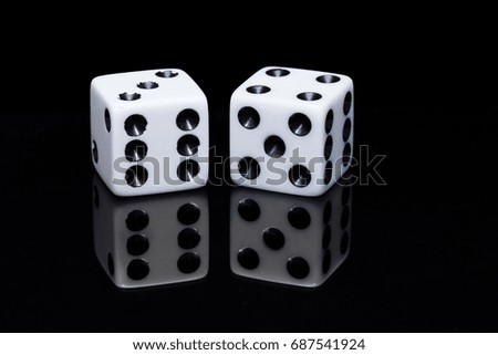 Gambling two dices on a mirroring dark black surface