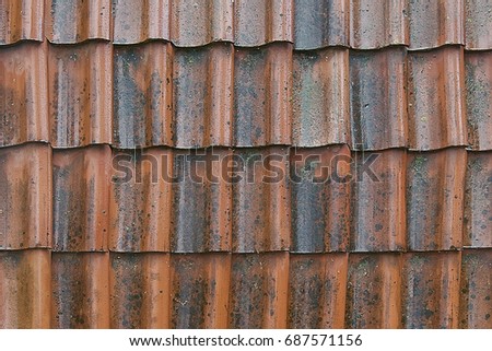Old red tile roof background texture close up