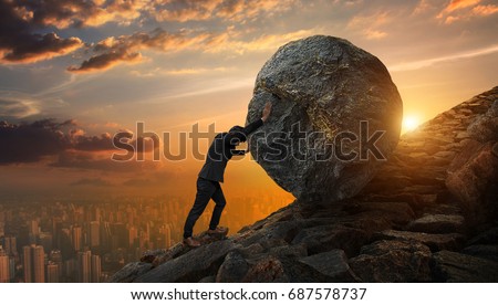 Business man pushing large stone up to hill , Business heavy tasks and problems concept. Royalty-Free Stock Photo #687578737