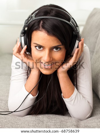girl listening to music on the sofa