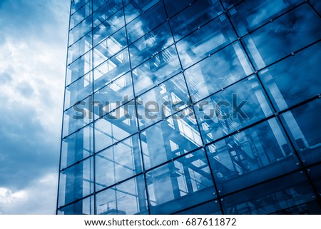 modern glass building with reflection,blue toned.