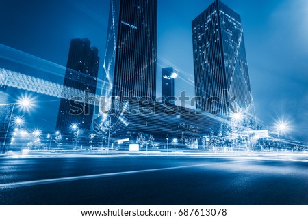 illuminated modern skyscrapers with traffic trails at night,tianjin city,china.