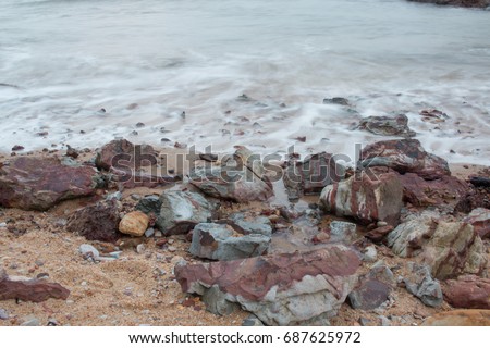 Long Exposure Beach. The rocks behind the soft water waves of the beach. located in Hill Keluang or Bukit Keluang in terengganu, Malaysia. 
